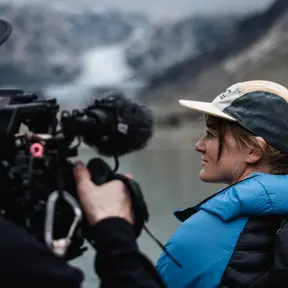 Me filming an interview in front of a glacier